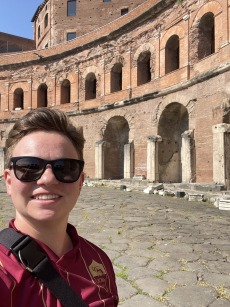 Selfie of Madeleine standing in front of Trajan's Markets in Rome